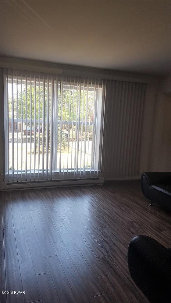 129 Roundhill Road Dingmans Ferry, PA 18328 - Photo 11 of 30 a view of an empty room with wooden floor and a window