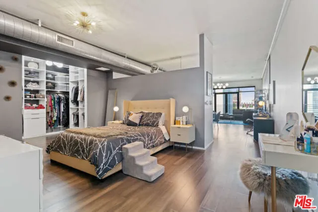 a bedroom with a bed and a large mirror