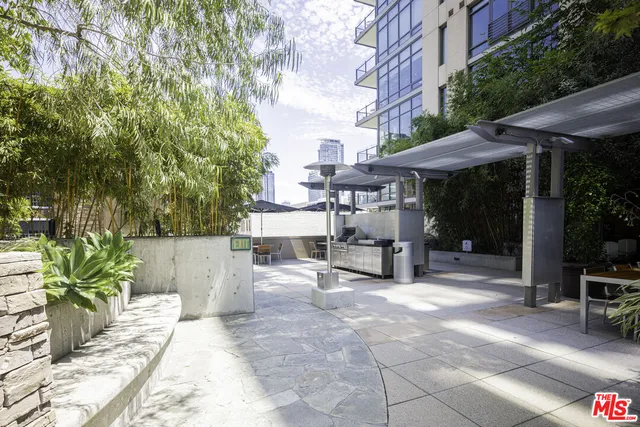 a view of a patio with a chairs and potted plants
