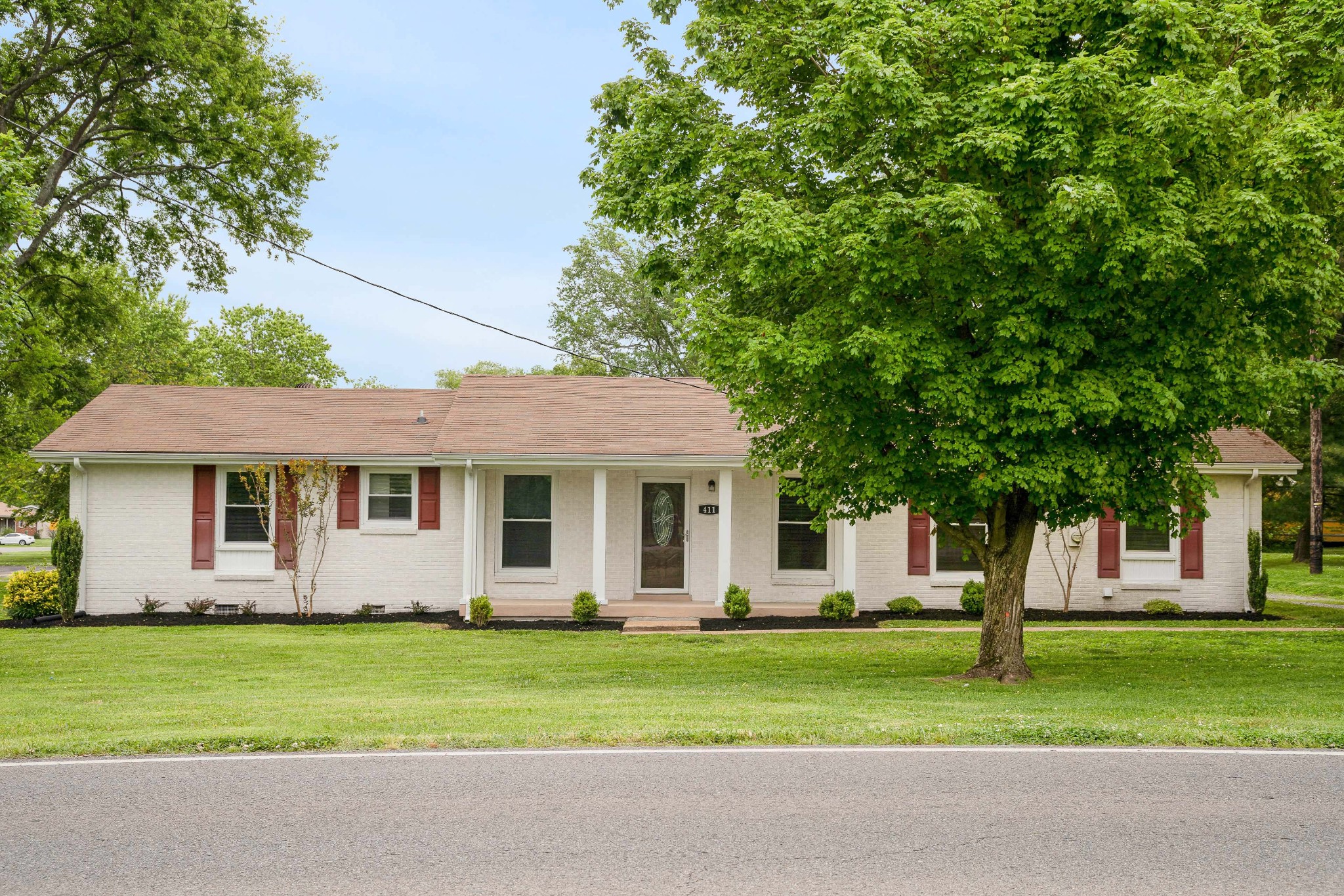 411 Walton Ferry Road Hendersonville, TN 37075 - Photo 1 of 26 a front view of a house with a garden