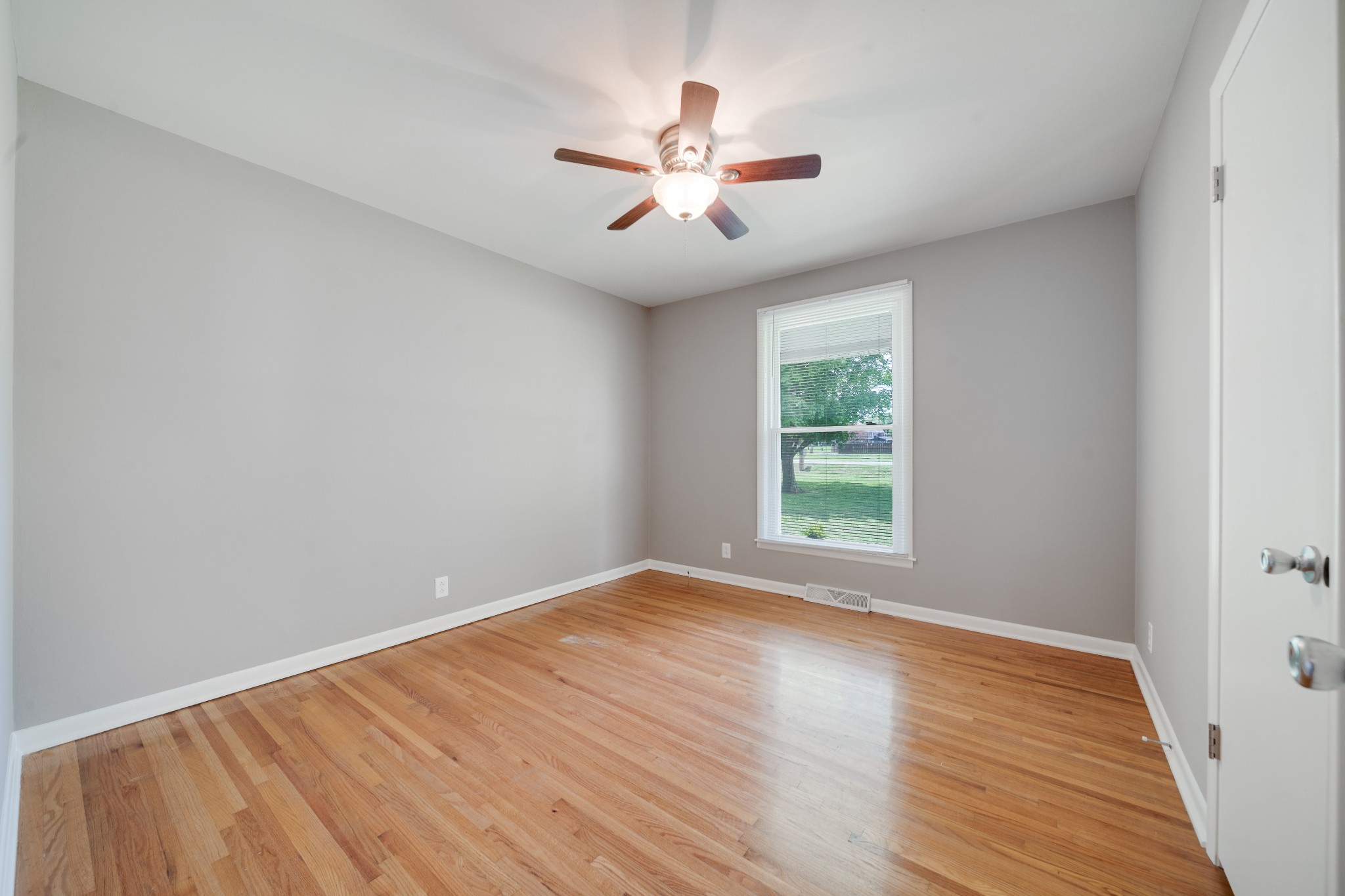 411 Walton Ferry Road Hendersonville, TN 37075 - Photo 13 of 26 wooden floor in an empty room with a window