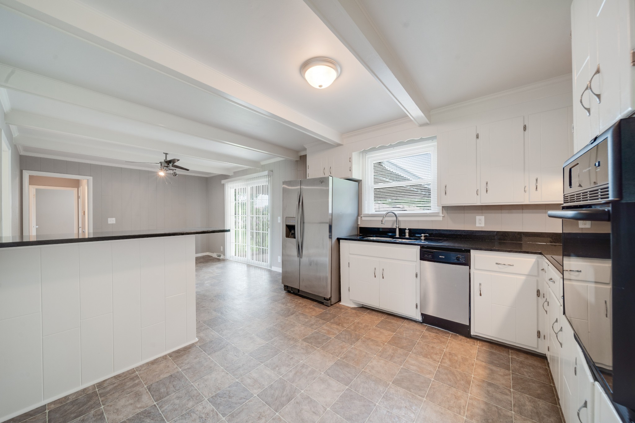 411 Walton Ferry Road Hendersonville, TN 37075 - Photo 6 of 26 a kitchen with granite countertop a refrigerator a sink a stove and white cabinets
