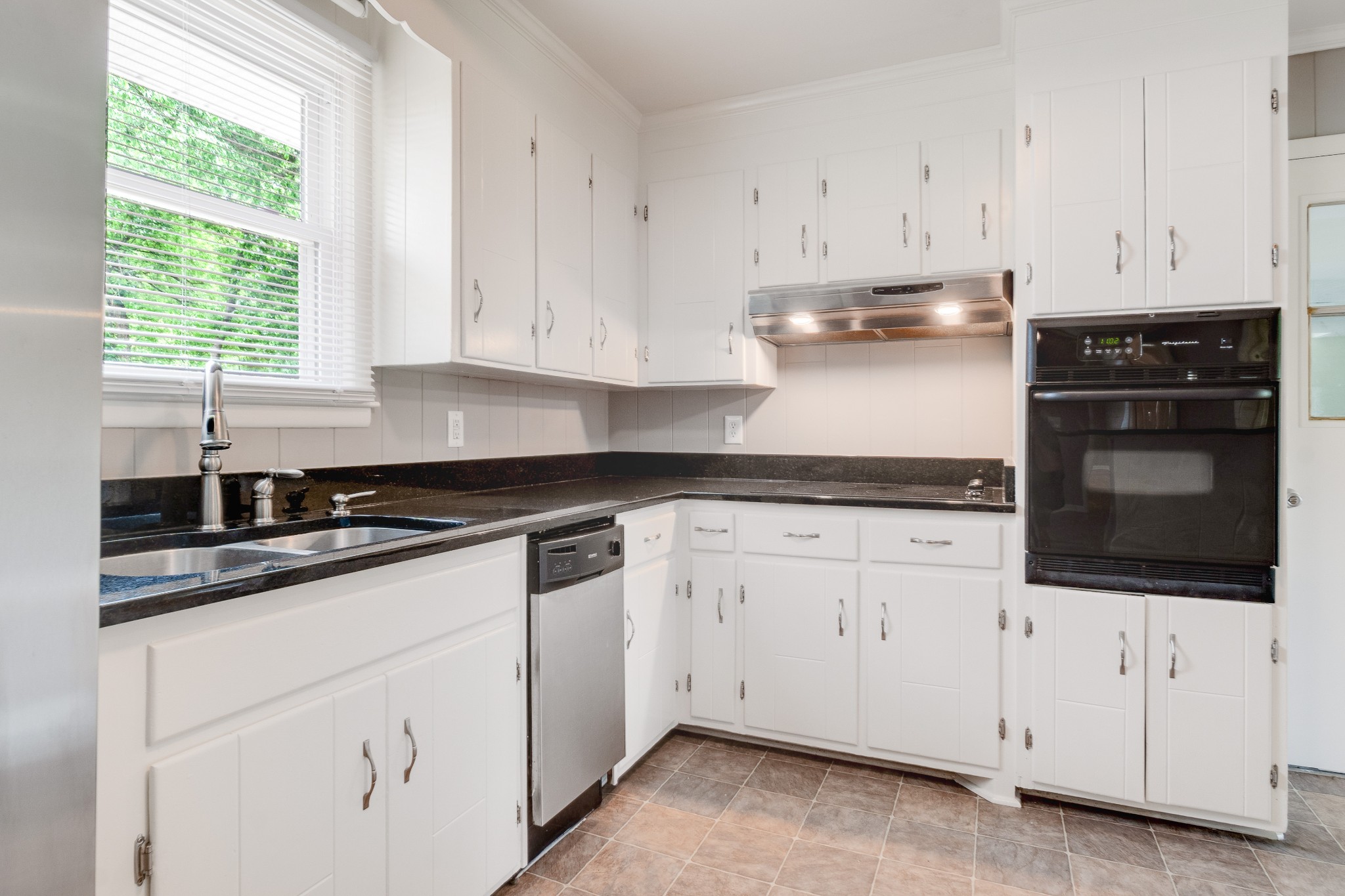 411 Walton Ferry Road Hendersonville, TN 37075 - Photo 9 of 26 a kitchen with granite countertop white cabinets and white appliances