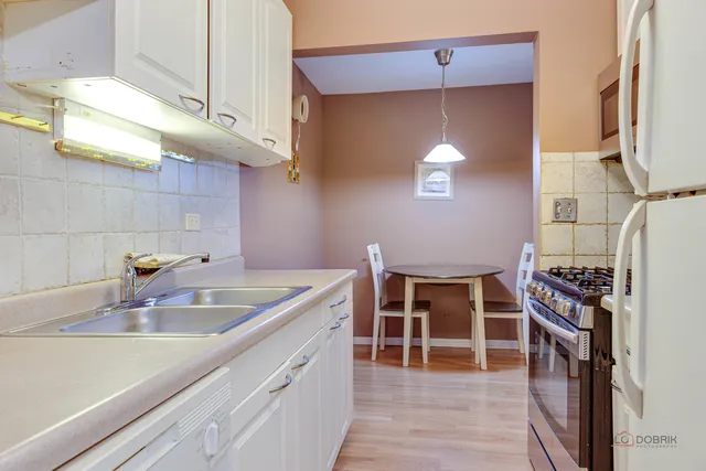 a kitchen with a sink and cabinets