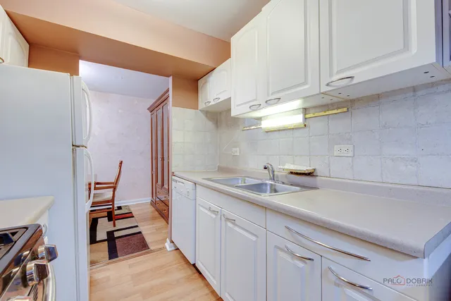 a kitchen with a sink and cabinets
