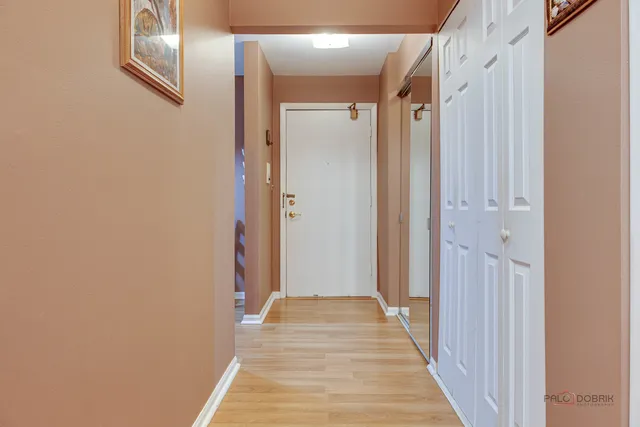 a view of a hallway with wooden floor