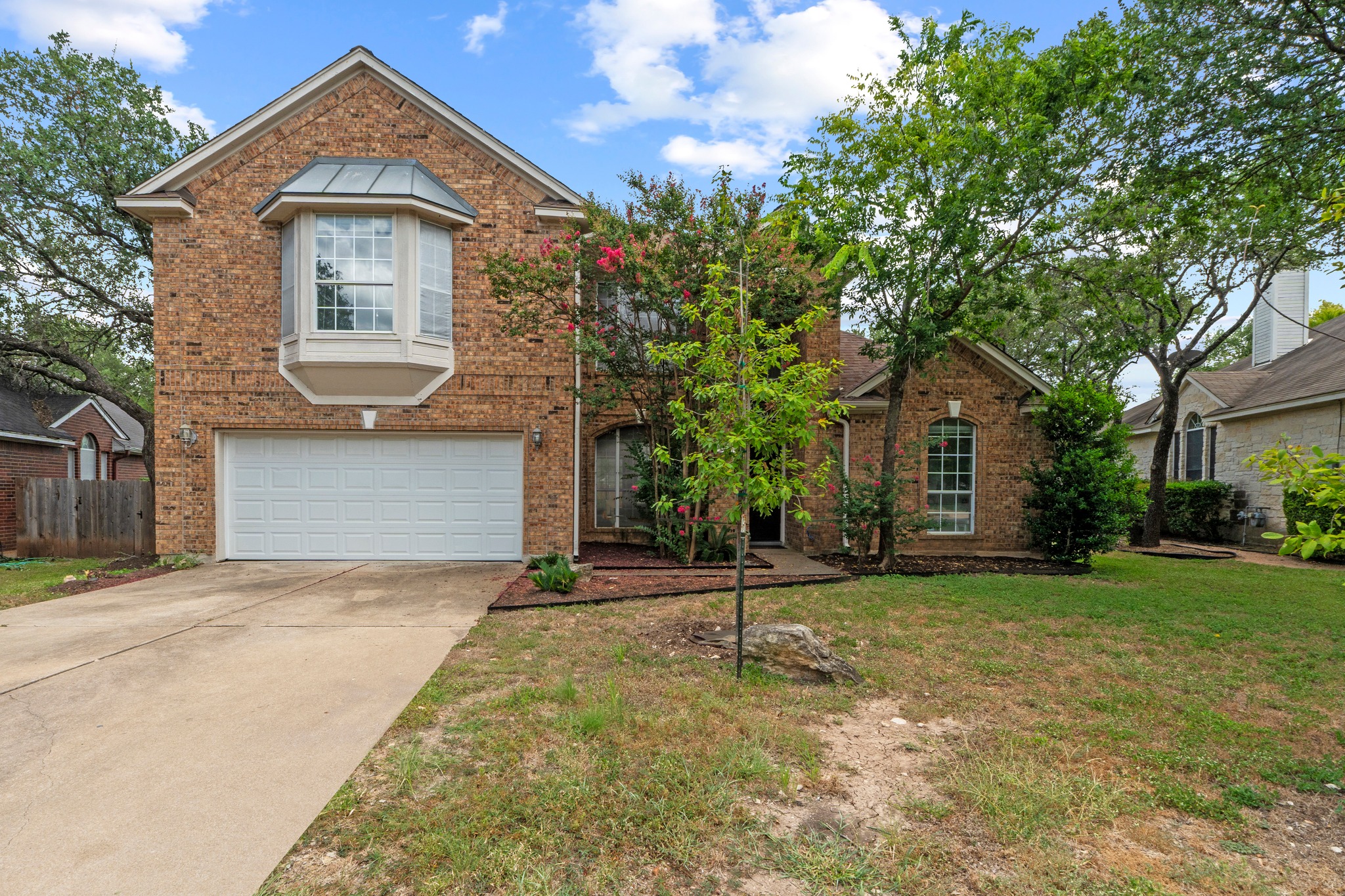 8605 Axis Drive Austin, TX 78749 - Photo 1 of 38 A classic brick facade welcomes guests with a bay window and an attached garage.