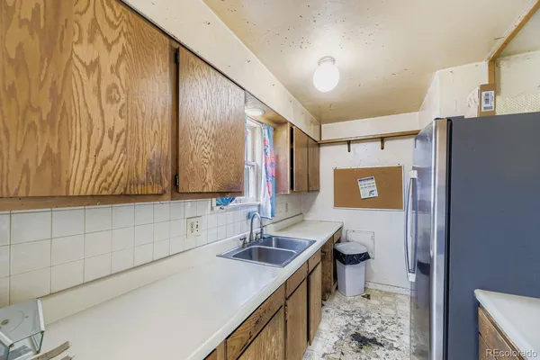 a kitchen with a sink and a refrigerator