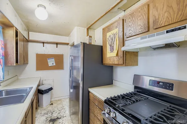 a kitchen with stainless steel appliances granite countertop a stove and a sink