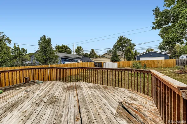 a view of balcony with wooden floor and fence