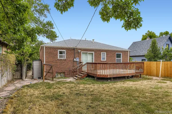 a view of a house with a yard and deck