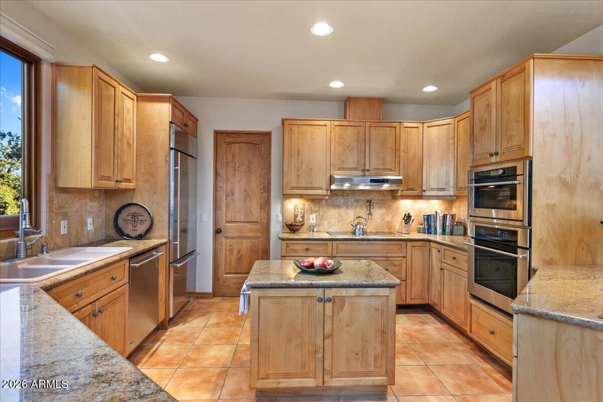 30 West Gunsmoke Road Sedona, AZ 86336 - Photo 16 of 73 a kitchen with stainless steel appliances granite countertop a sink stove and refrigerator