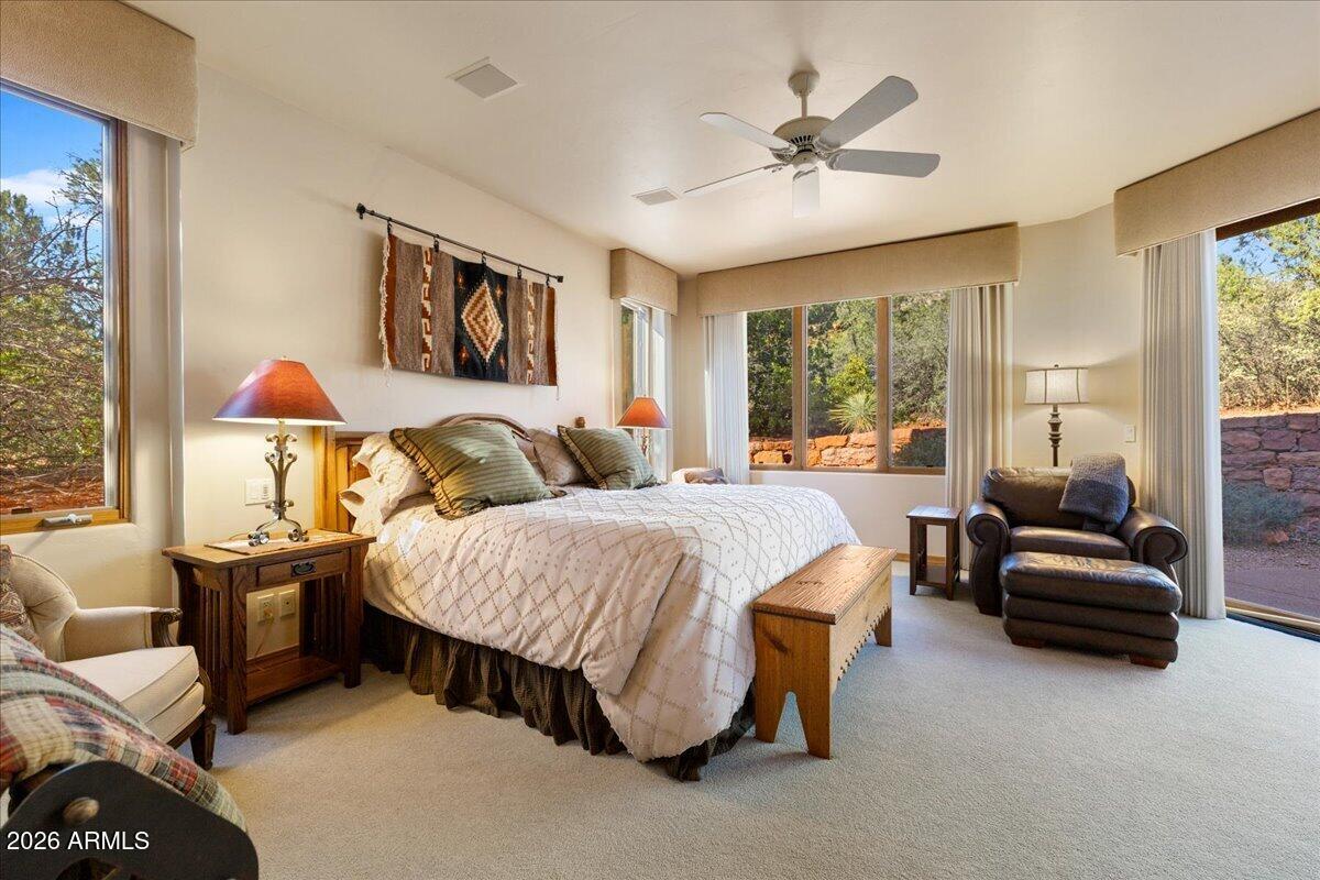30 West Gunsmoke Road Sedona, AZ 86336 - Photo 23 of 73 a spacious bedroom with a bed and a chandelier