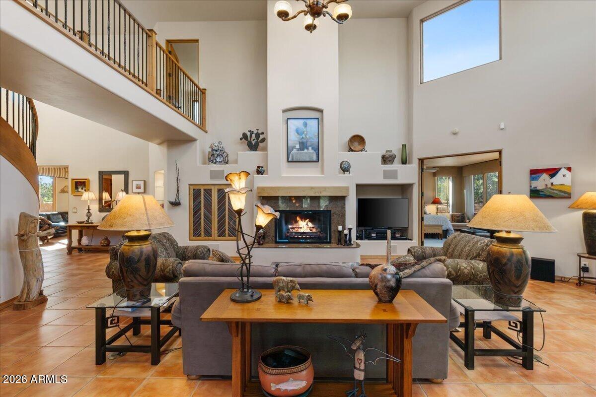 30 West Gunsmoke Road Sedona, AZ 86336 - Photo 3 of 73 a living room with furniture a fireplace and a large window