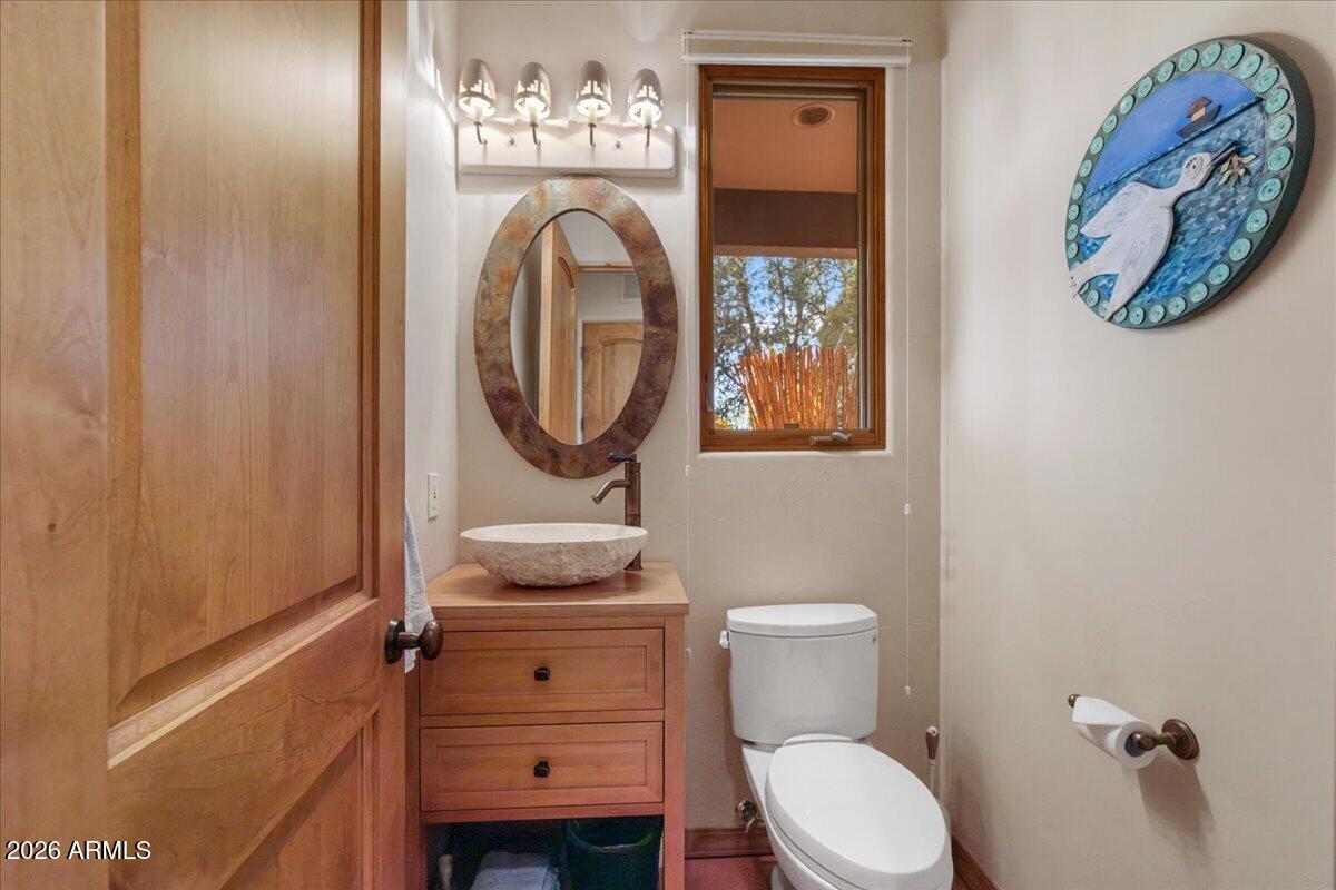 30 West Gunsmoke Road Sedona, AZ 86336 - Photo 31 of 73 a bathroom with a toilet a sink and mirror