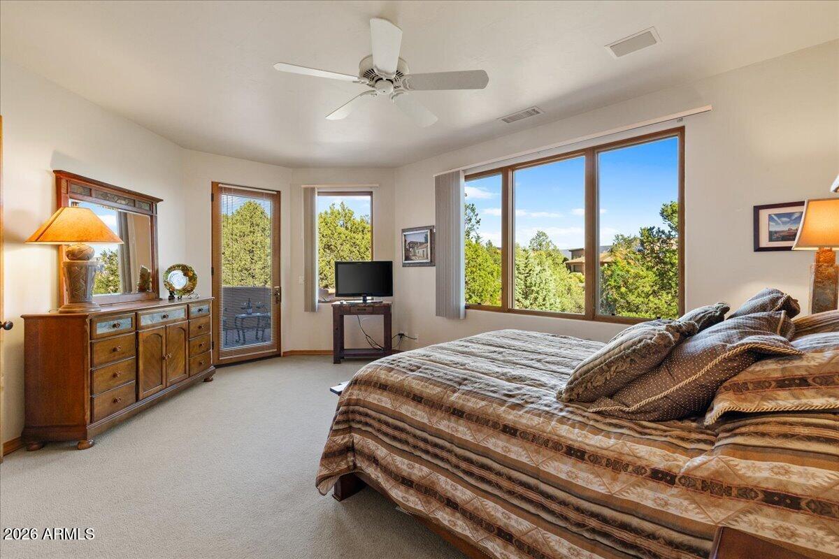 30 West Gunsmoke Road Sedona, AZ 86336 - Photo 34 of 73 a bed sitting in a spacious bedroom next to a window