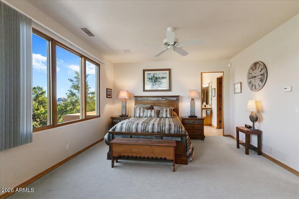 30 West Gunsmoke Road Sedona, AZ 86336 - Photo 36 of 73 a spacious bedroom with a bed and a large window