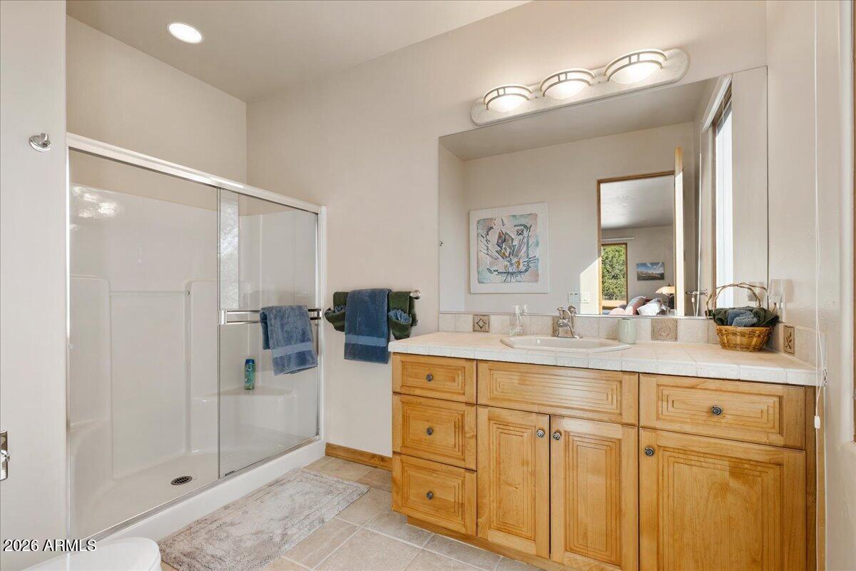 30 West Gunsmoke Road Sedona, AZ 86336 - Photo 47 of 73 a spacious bathroom with a shower sink and mirror