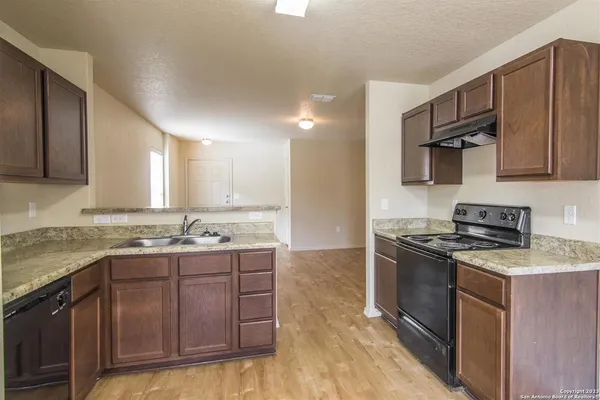 a kitchen with stainless steel appliances granite countertop a stove a sink and a microwave