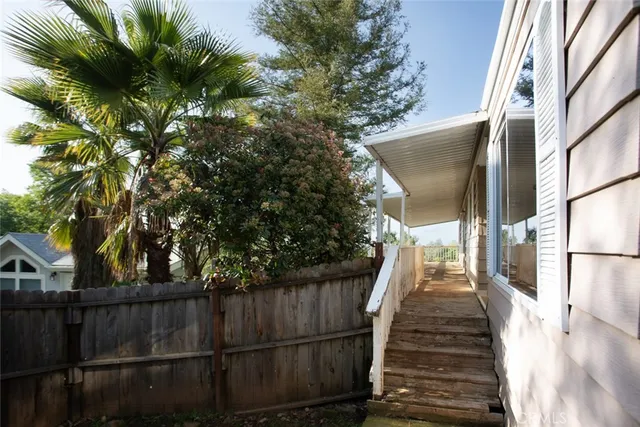 a view of a yard with a fence and trees
