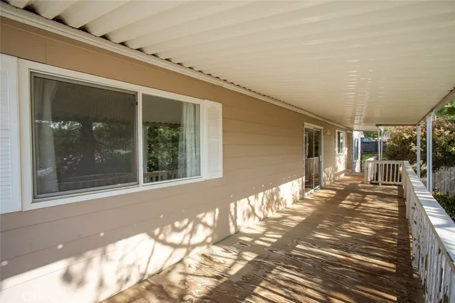 a view of balcony with wooden floor and fence