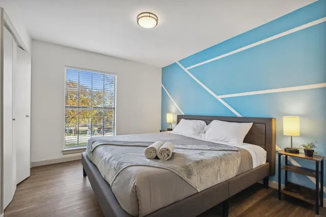 a bedroom with a large bed and a window