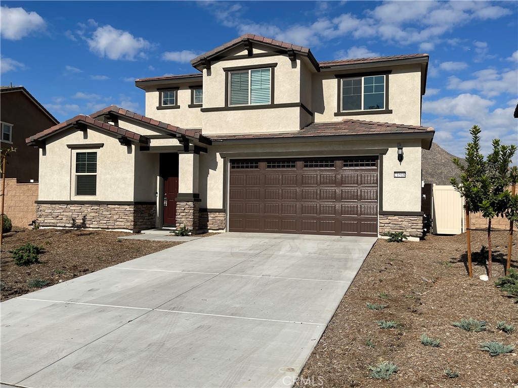 21518 Milam Drive Colton, CA 92324 - Photo 1 of 4 a front view of a house with a yard and garage