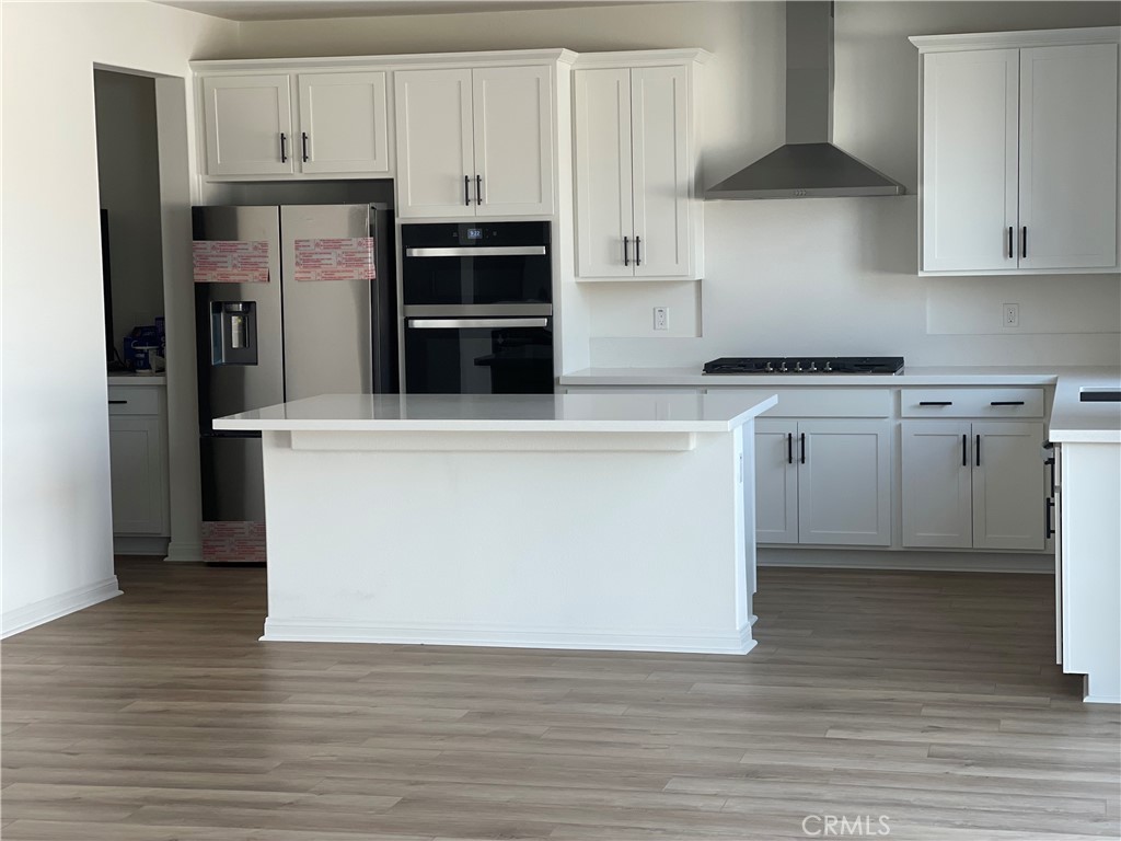 21518 Milam Drive Colton, CA 92324 - Photo 2 of 4 a kitchen with stainless steel appliances granite countertop a stove a refrigerator and a microwave