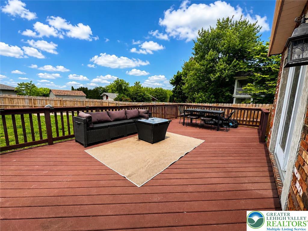 10 Dusty Road Easton, PA 18045 - Photo 8 of 35 An inviting outdoor space features a spacious wooden deck, ideal for entertaining under the blue sky.