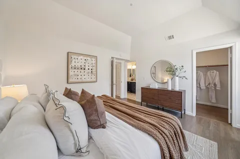 a bed room with a bed and a mirror
