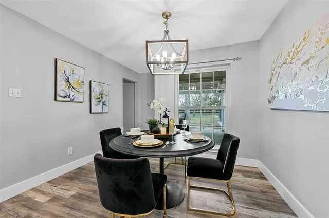 a dining room with furniture a window and wooden floor