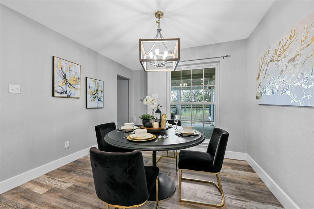 303 Riva Ridge Wylie, TX 75098 - Photo 14 of 38 a dining room with furniture a window and wooden floor
