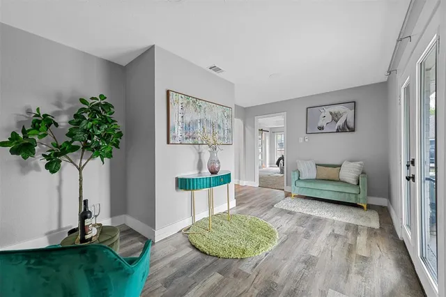 a living room with furniture and a potted plant