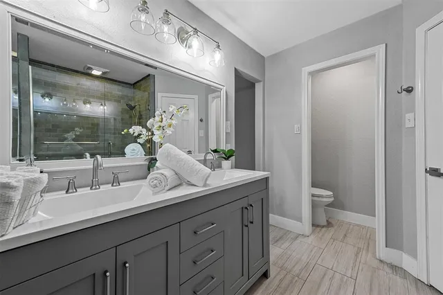 a bathroom with a double vanity sink and a mirror