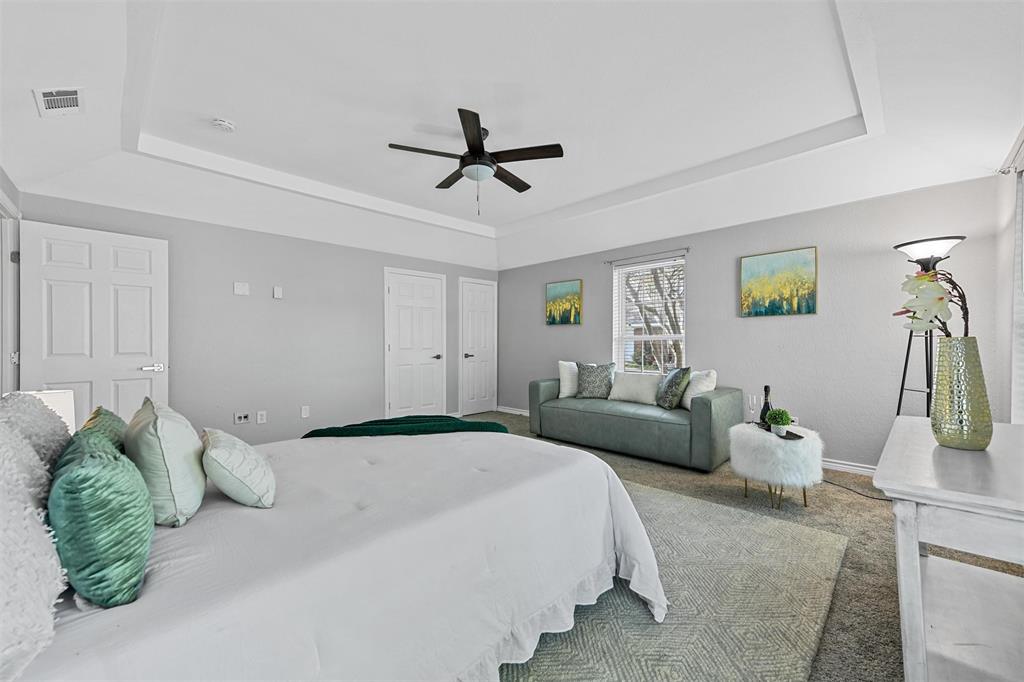 303 Riva Ridge Wylie, TX 75098 - Photo 27 of 38 a bedroom with a bed mirror and couch