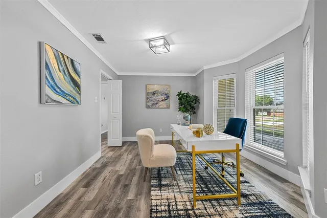 a view of a dining room with furniture a rug and wooden floor
