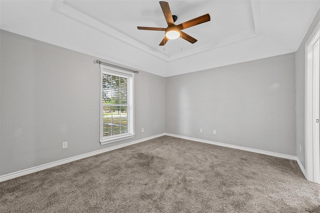 303 Riva Ridge Wylie, TX 75098 - Photo 32 of 38 an empty room with a window and a fan