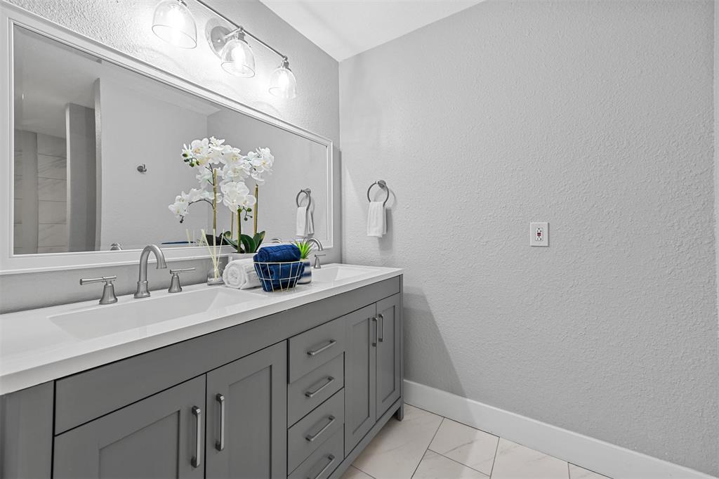 303 Riva Ridge Wylie, TX 75098 - Photo 33 of 38 a bathroom with a sink vanity and a mirror