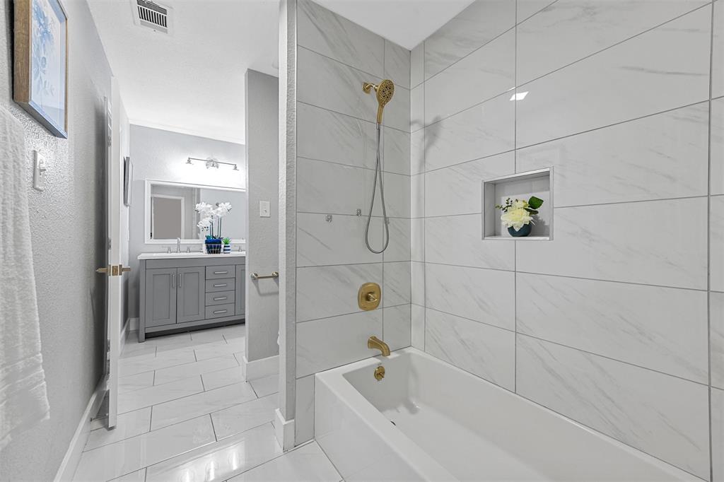 303 Riva Ridge Wylie, TX 75098 - Photo 34 of 38 a bathroom with a bathtub a shower a sink and mirror