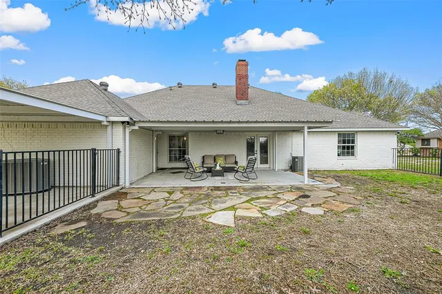 a view of a house with backyard porch and sitting area