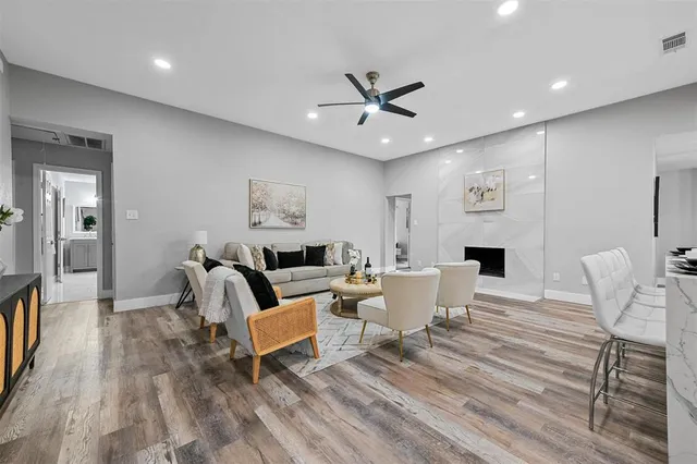 a living room with furniture a window and a chandelier