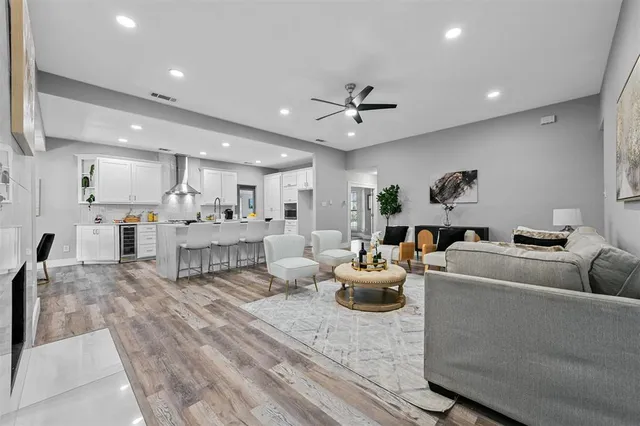 a living room with furniture and a view of kitchen