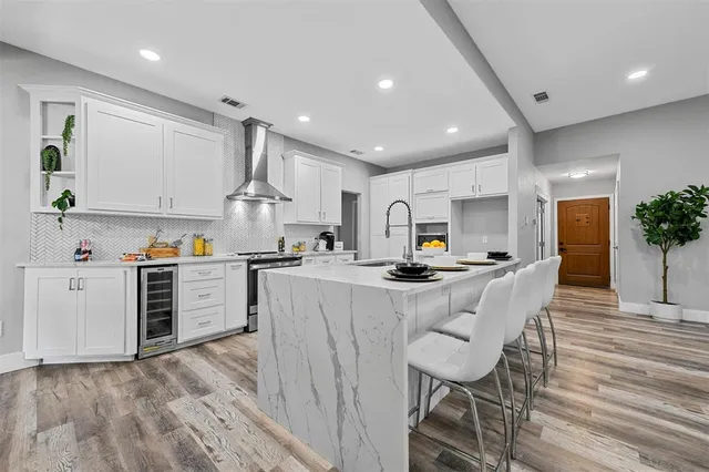 a view of kitchen with sink microwave refrigerator and stove