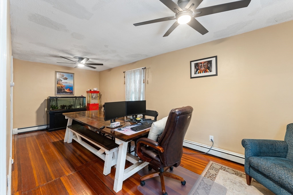 185 West Avenue Pawtucket, RI 02860 - Photo 23 of 40 a workspace with furniture and a chandelier fan