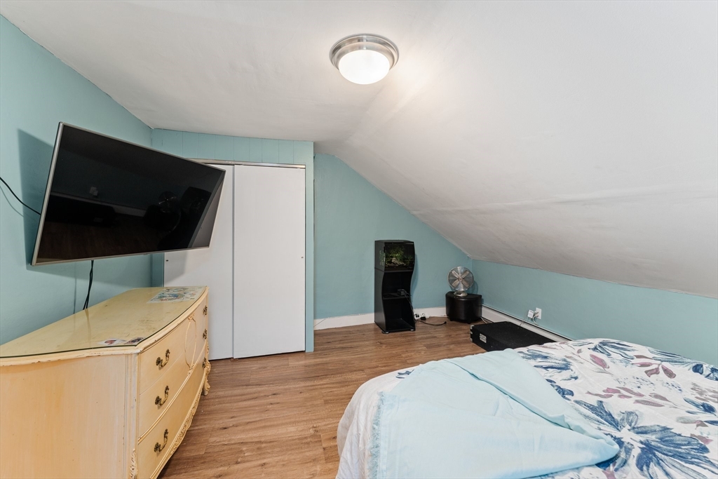185 West Avenue Pawtucket, RI 02860 - Photo 29 of 40 a bedroom with a bed and a flat screen tv
