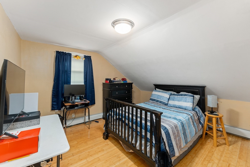 185 West Avenue Pawtucket, RI 02860 - Photo 32 of 40 a bedroom with furniture and a flat screen tv
