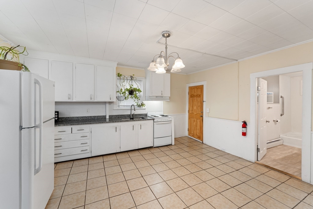 185 West Avenue Pawtucket, RI 02860 - Photo 7 of 40 a kitchen with granite countertop white cabinets and white appliances