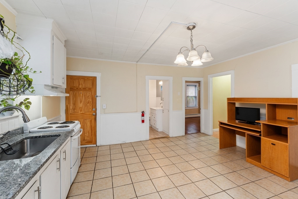 185 West Avenue Pawtucket, RI 02860 - Photo 8 of 40 a kitchen that has a microwave a stove and a sink