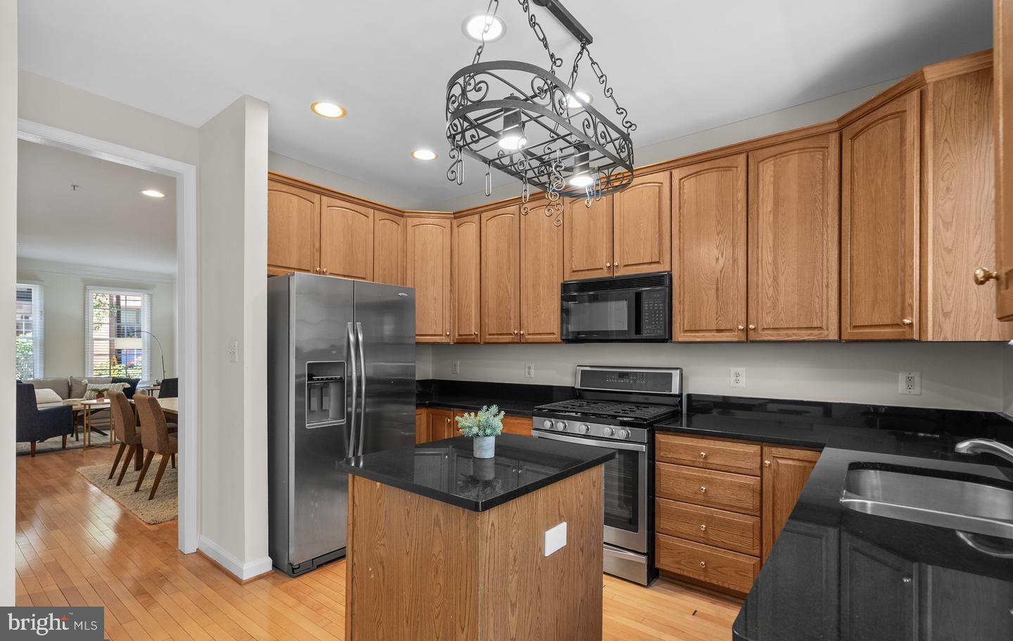 8509 2nd Avenue Silver Spring, MD 20910 - Photo 4 of 16 a kitchen with stainless steel appliances granite countertop a refrigerator a sink a stove a microwave and cabinets
