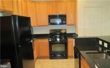 a kitchen with a refrigerator and a stove